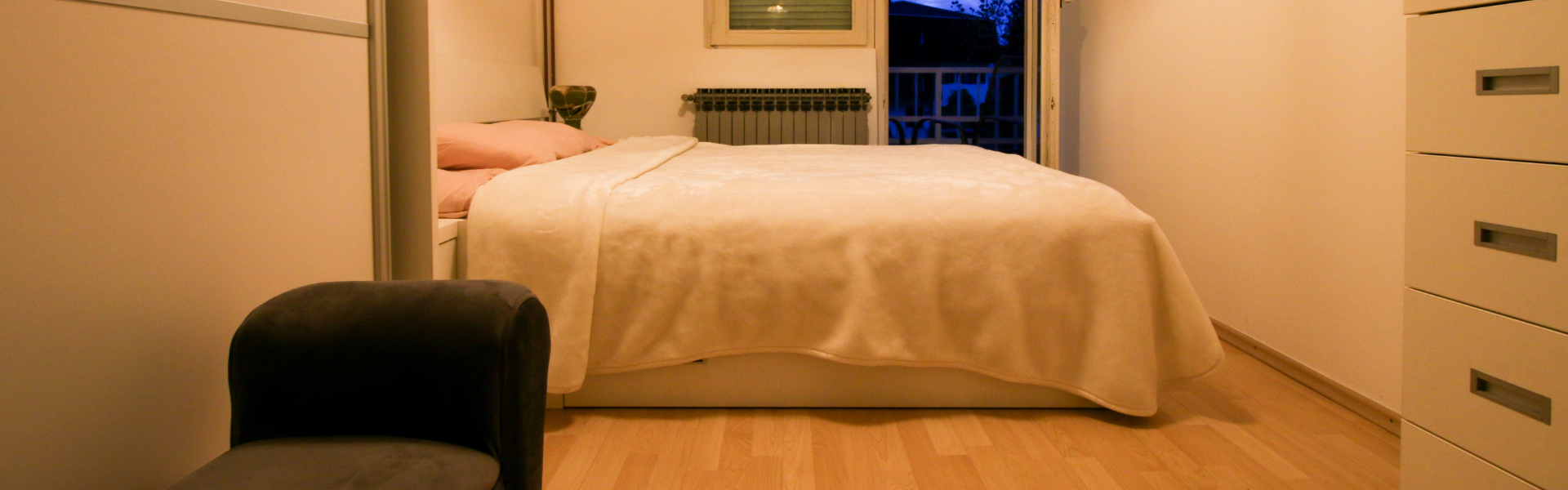 The image shows a bedroom in Room Dugave Two.