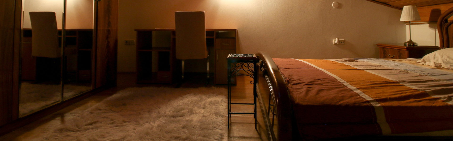 The image shows a bedroom in Room Dugave Five.