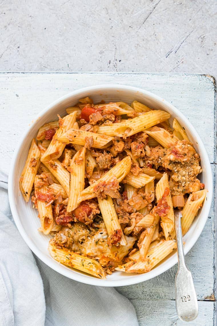 cheesy tuna casserole served in a bowl with a silver spoon